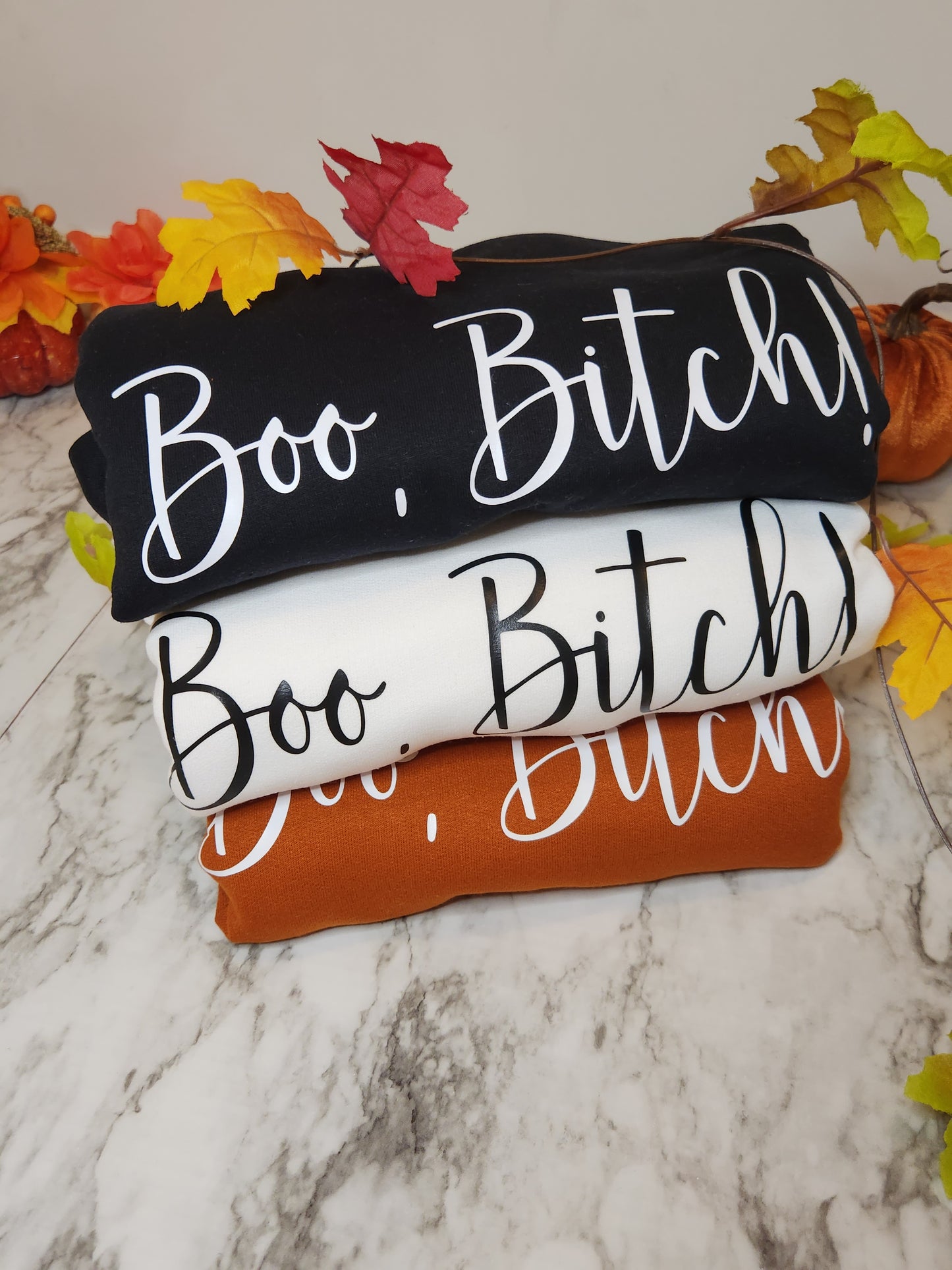 Black sweatshirt with white boo bitch, white sweatshirt with black boo bitch and burnt orange sweatshirt with white boo bitch.