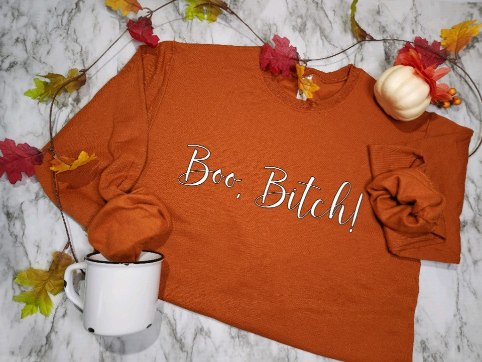 Burnt orange sweatshirt with Boo Bitch in white.